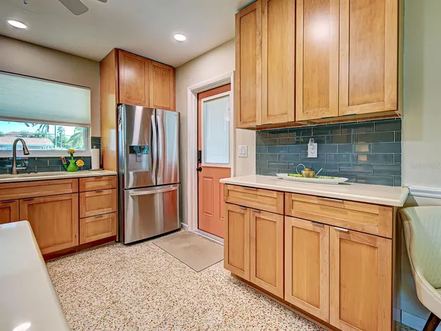 a kitchen with stainless steel appliances granite countertop a refrigerator sink and cabinets