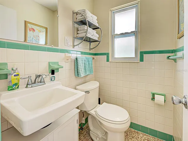 a bathroom with a sink a toilet and a window