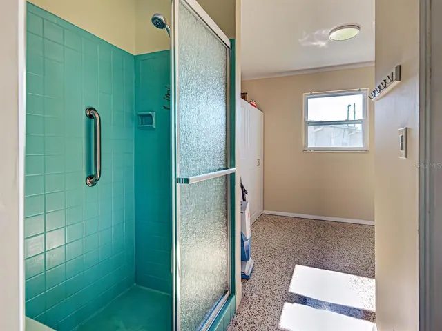 a bathroom with a shower and a mirror