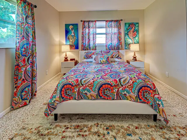 a bedroom with a bed and a painting on the wall