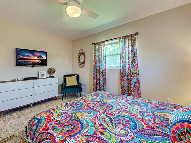 a bed room with furniture and a flat screen tv