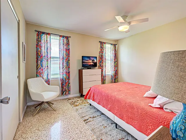 a bedroom with a bed and a chair