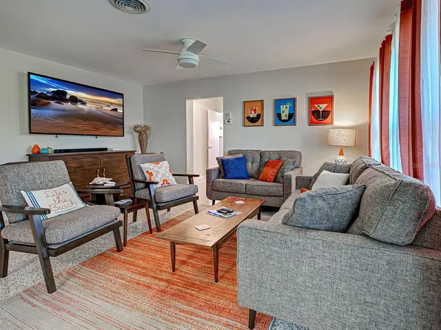 a living room with furniture and a rug