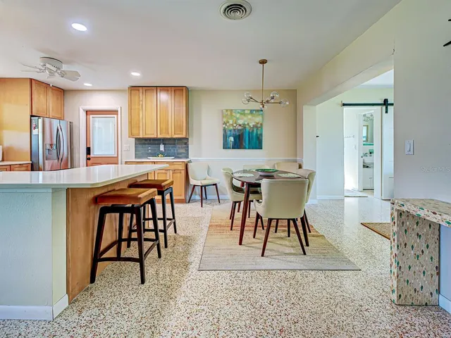 a view of a a dining room with furniture window and wooden floor