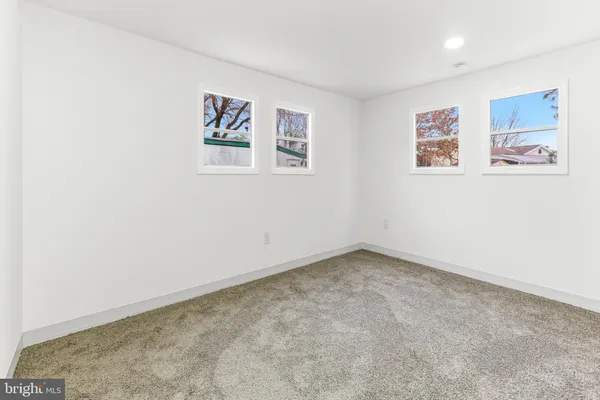 an empty room with a painting on the wall