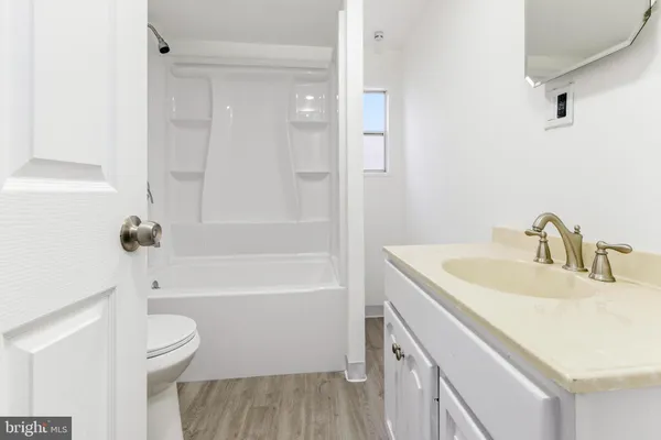 a bathroom with a sink a toilet and a bathtub