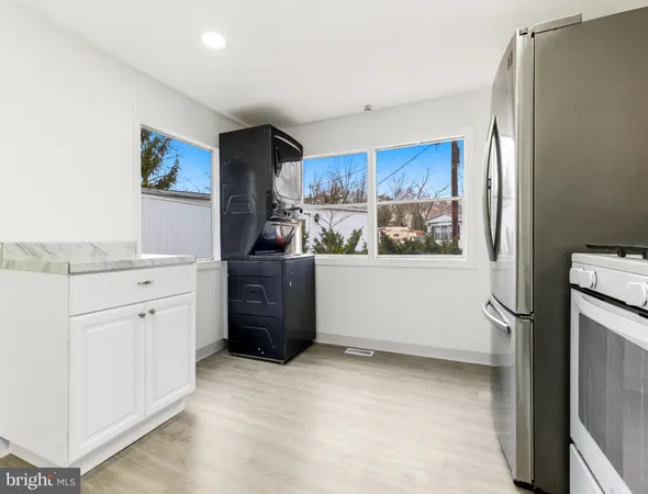 a kitchen with stainless steel appliances a refrigerator and cabinets