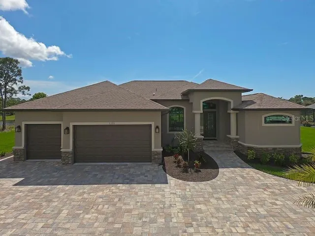 a front view of a house with a yard and garage