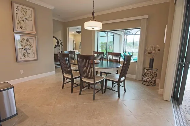 a dining room with furniture a chandelier and a rug
