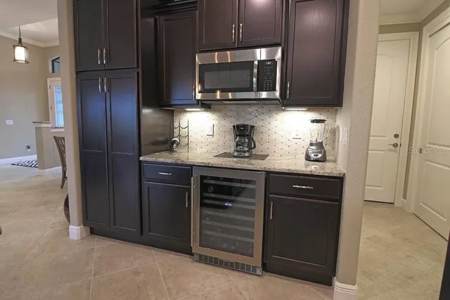 a kitchen with stainless steel appliances granite countertop a stove microwave and refrigerator