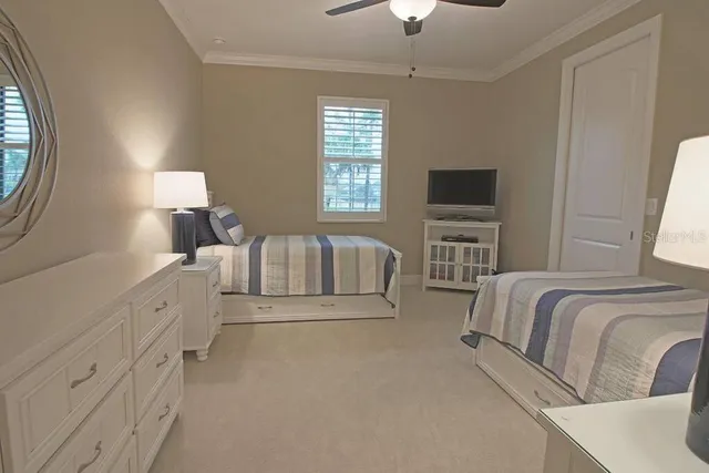 a spacious bedroom with a bed and a flat screen tv