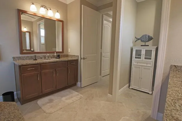 a bathroom with a double vanity sink a toilet and a mirror