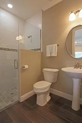 a bathroom with a toilet sink and a mirror
