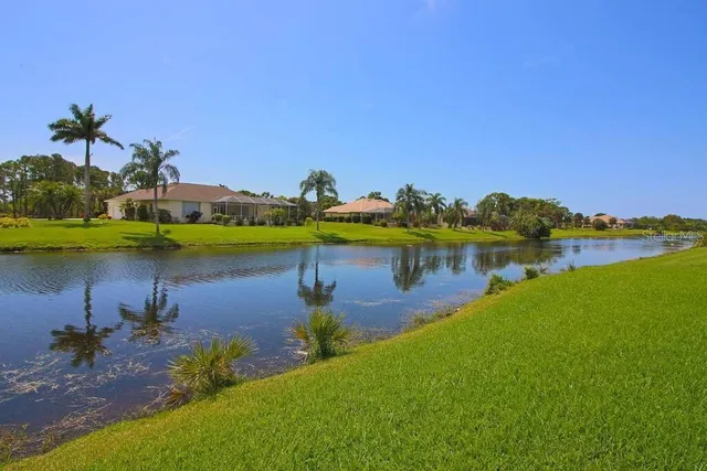 a view of a lake with houses in the back
