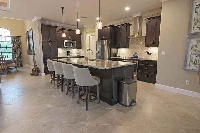 a large kitchen with a table and chairs