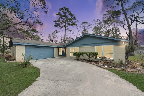 a front view of a house with a garden and yard