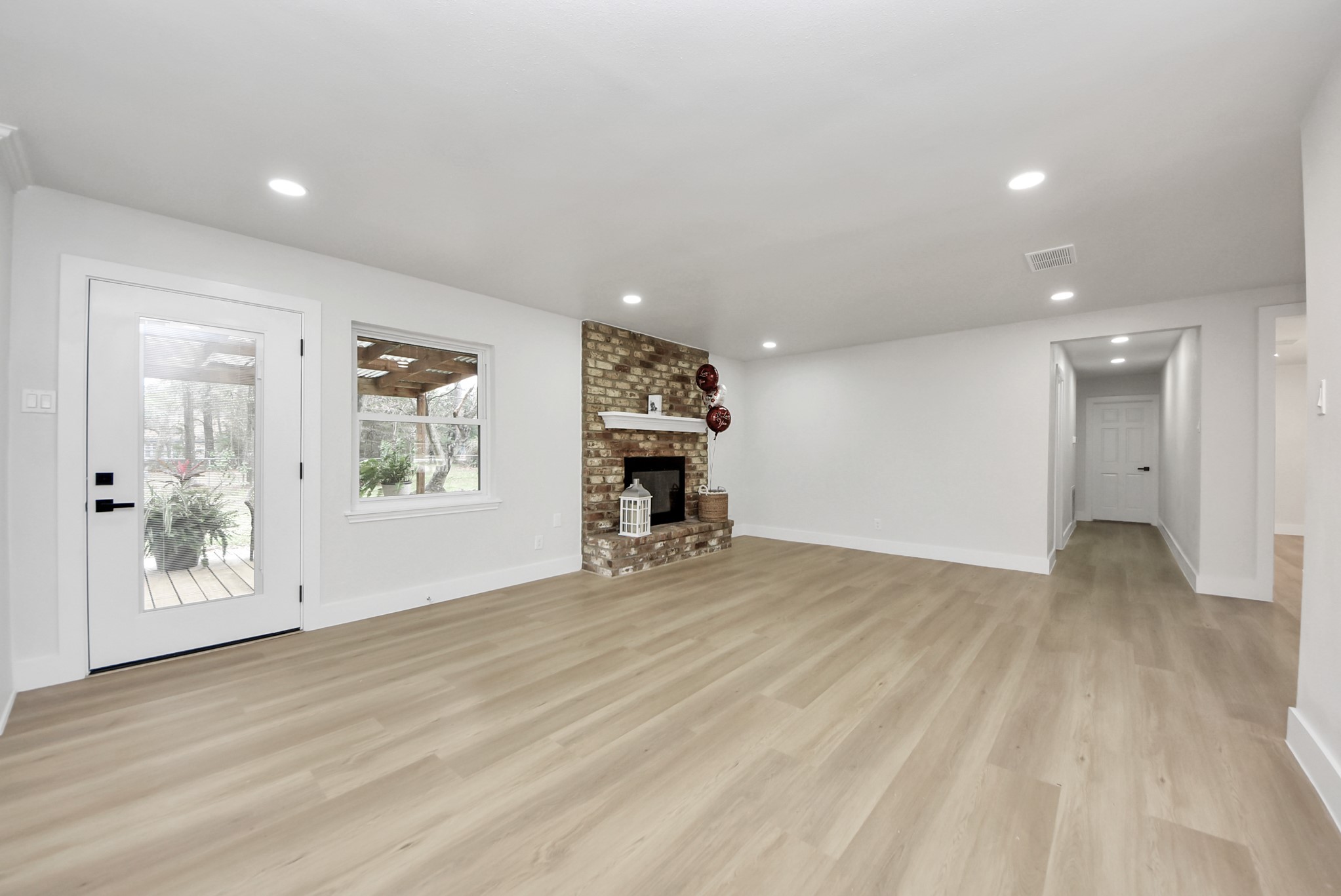 26206 Maplewood Drive Spring, TX 77386 - Photo 16 of 47 an empty room with wooden floor and windows