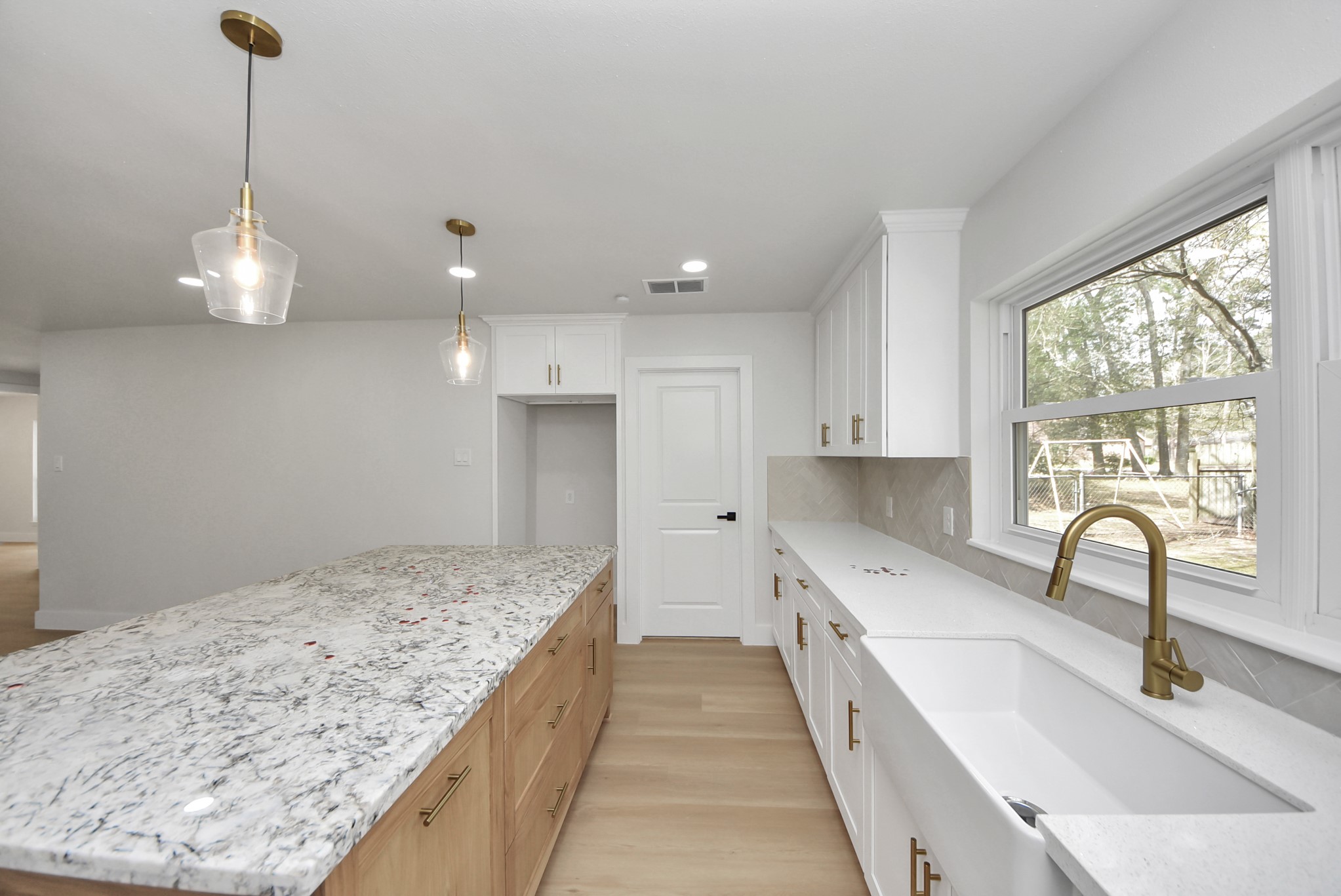26206 Maplewood Drive Spring, TX 77386 - Photo 25 of 47 a view of a kitchen with a sink and wooden floor