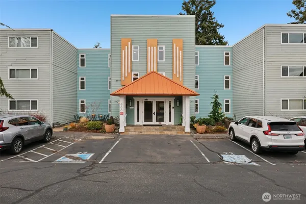 a view of a cars park in front of a building