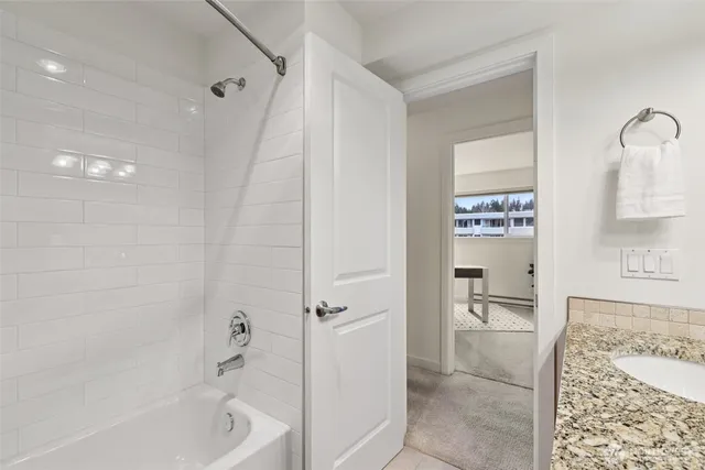 a bathroom with a bathtub and a shower