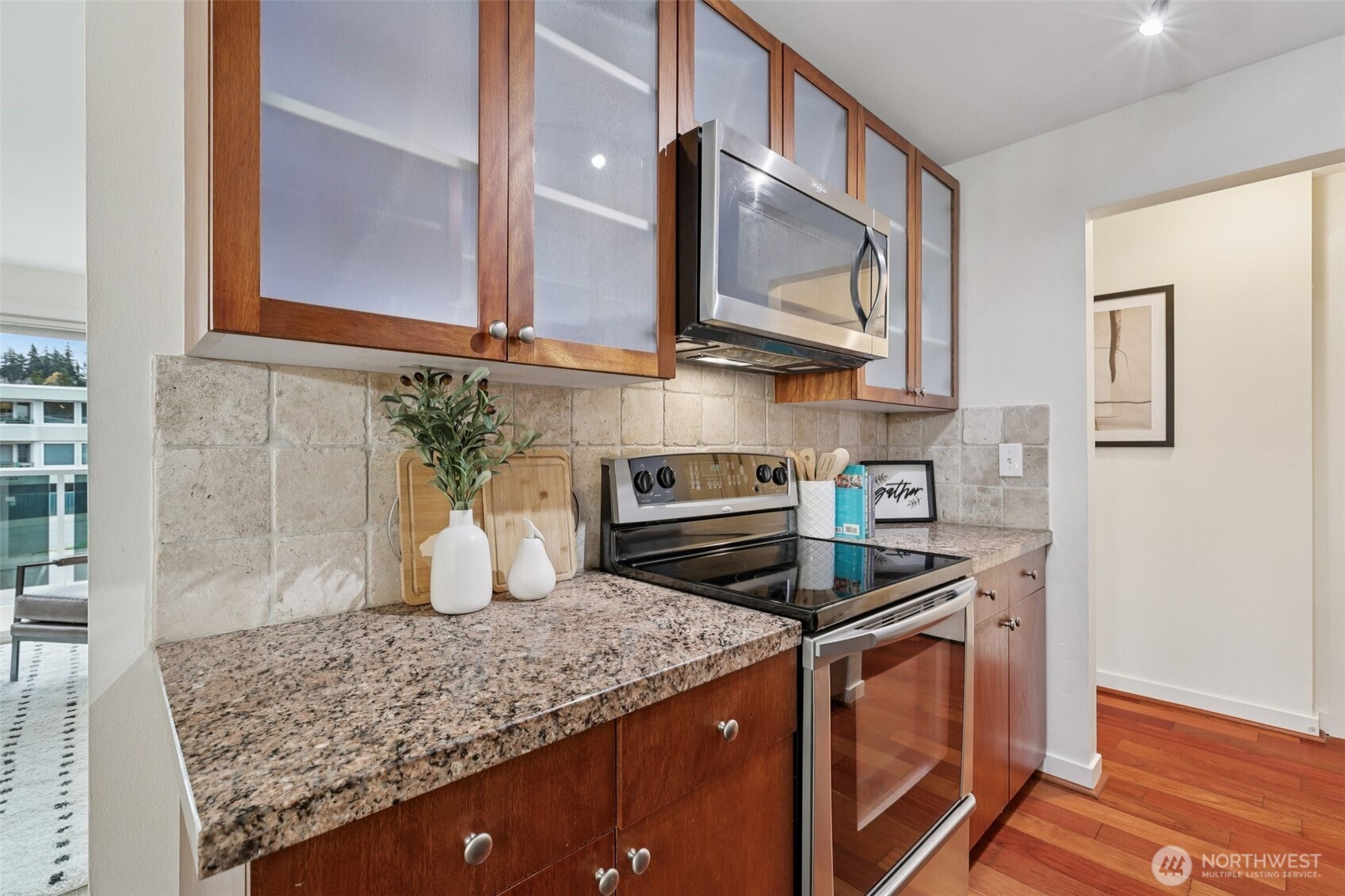 960 5th Avenue South, Unit 208 Edmonds, WA 98020 - Photo 7 of 26 a kitchen with stainless steel appliances granite countertop a sink stove and cabinets