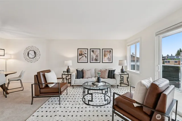 a living room with furniture a rug and a table