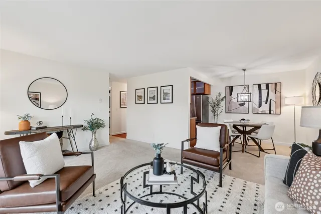 a living room with furniture a rug and a window