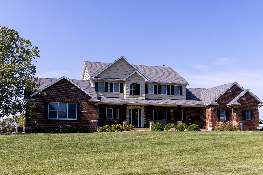 12747 Harrold Point Road Wapella, IL 61777 - Photo 1 of 48 a front view of a house with a garden