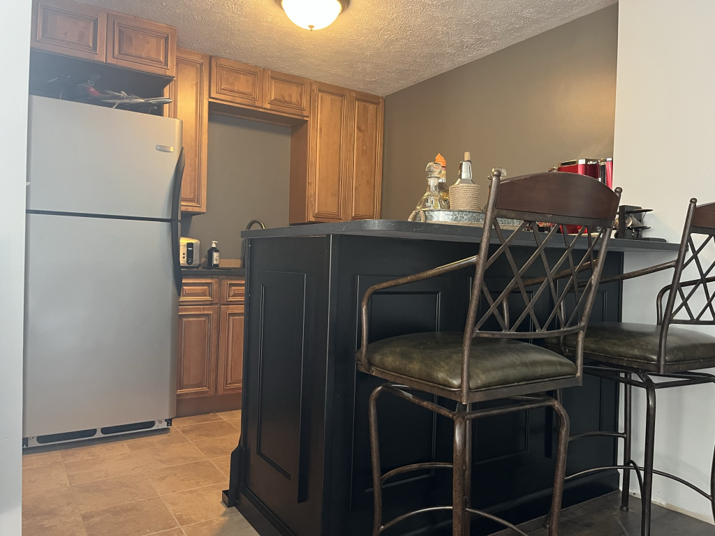 12747 Harrold Point Road Wapella, IL 61777 - Photo 36 of 48 a kitchen with a refrigerator and a microwave