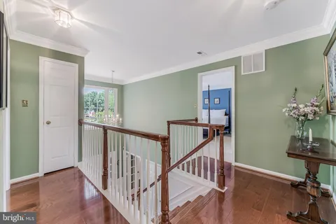 a large bed sitting in a bedroom next to a window