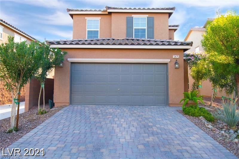 5475 Ordesa Valley Road Las Vegas, NV 89148 - Photo 1 of 35 A neatly paved driveway leads to this charming two-story home, showcasing lush desert-friendly landscaping.
