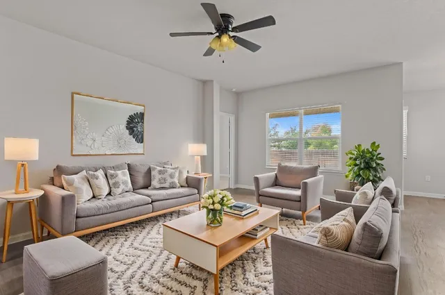 a living room with furniture and a large window