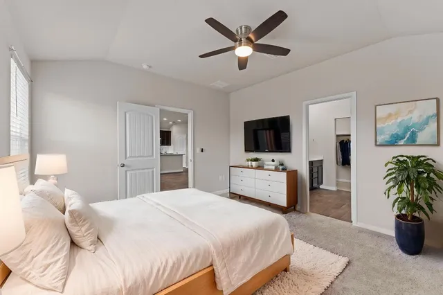 a bedroom with a bed and a flat screen tv