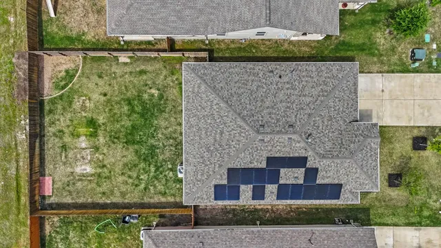 front view of a brick house with a yard