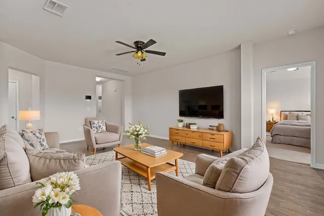 a living room with furniture and a flat screen tv