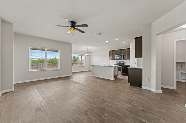 a view of a kitchen with microwave and a ceiling fan