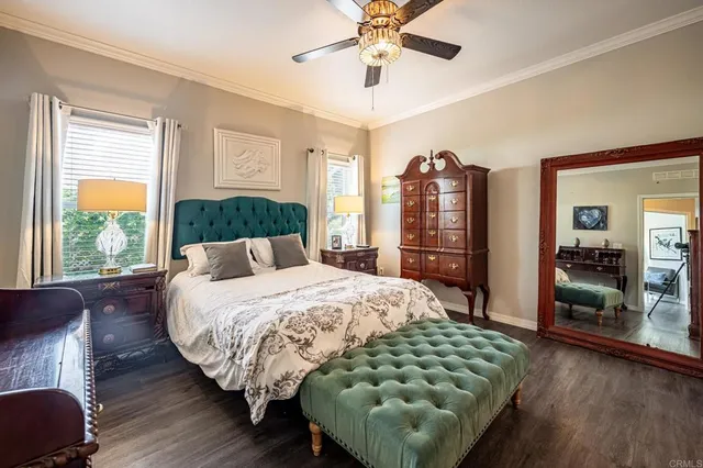 a bedroom with a large bed and a chandelier