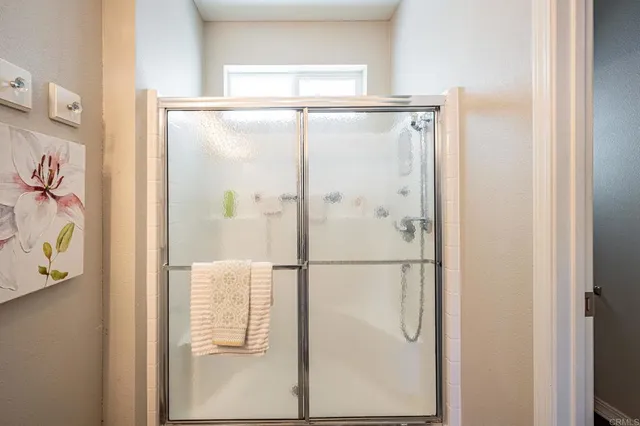 a bathroom with a glass shower door