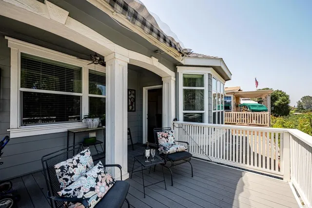a balcony with furniture and a window