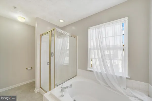 a bathroom with a shower and a tub