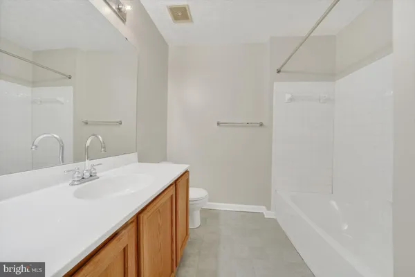 a bathroom with a sink a mirror and a bathtub