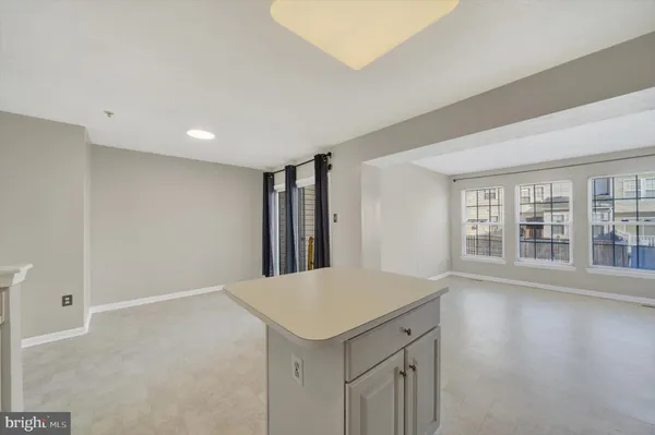 a view of a kitchen with wooden floor and a window