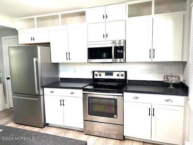 8 Augusta Road, Unit 73 Whiting, NJ 08759 - Photo 12 of 22 a kitchen with stainless steel appliances a stove a microwave and a refrigerator