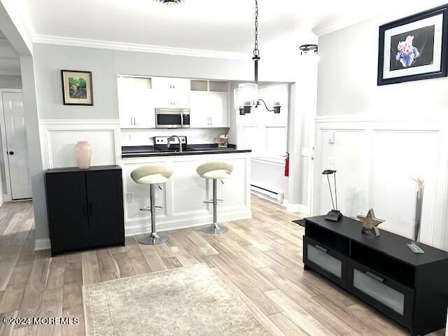 8 Augusta Road, Unit 73 Whiting, NJ 08759 - Photo 6 of 22 a kitchen with stainless steel appliances kitchen island granite countertop a refrigerator a sink dishwasher and white cabinets with wooden floor