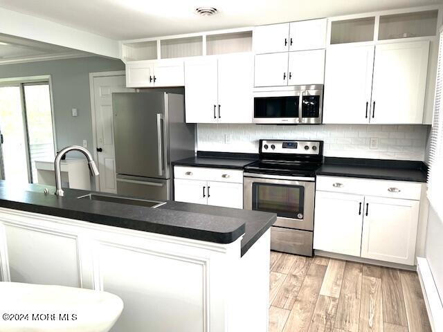 8 Augusta Road, Unit 73 Whiting, NJ 08759 - Photo 7 of 22 a kitchen with a sink a stove and microwave
