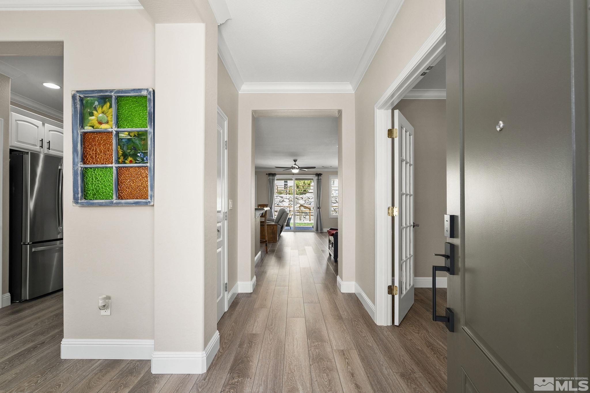 1005 Meridian Ranch Drive Reno, NV 89523 - Photo 4 of 40 a view of a hallway with wooden floor and a living room