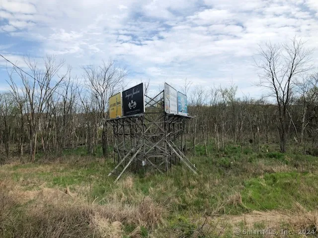 a backyard of a house with lots of green space and chair