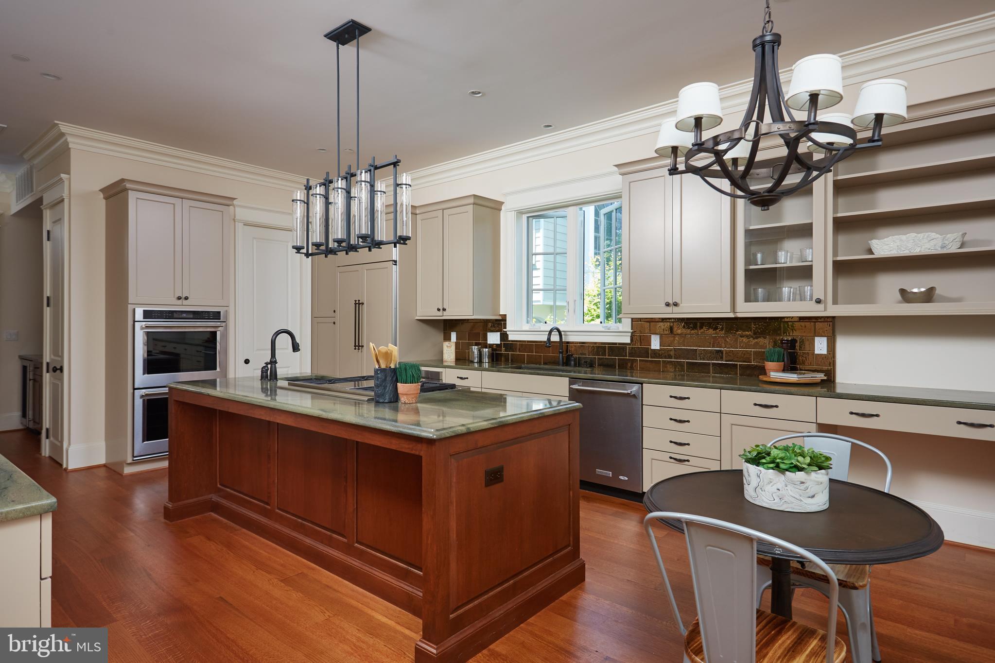 8003 Maple Ridge Road Bethesda, MD 20814 - Photo 13 of 30 a kitchen with kitchen island granite countertop a sink cabinets and wooden floor