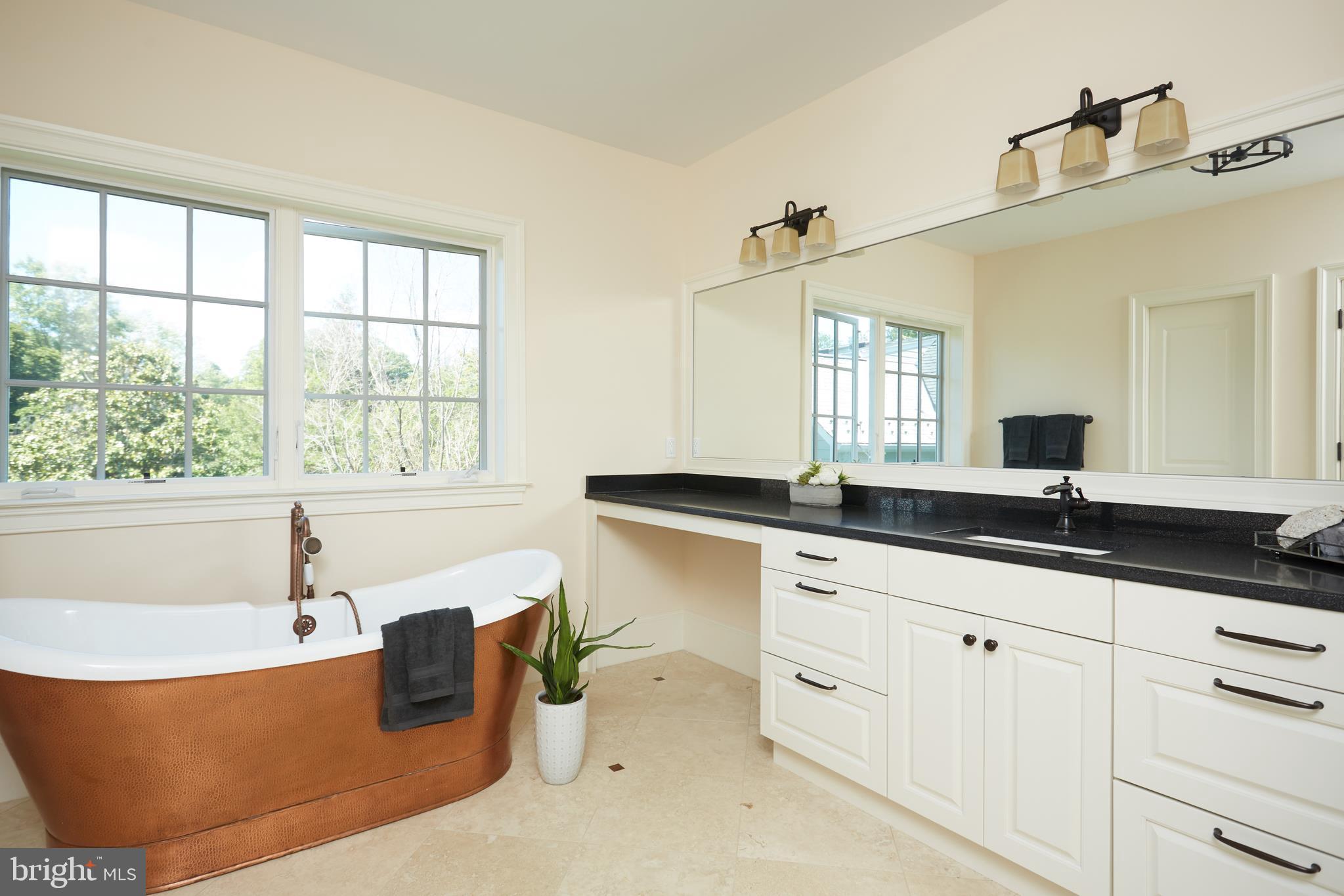 8003 Maple Ridge Road Bethesda, MD 20814 - Photo 29 of 30 a bathroom with a granite countertop tub sink and mirror
