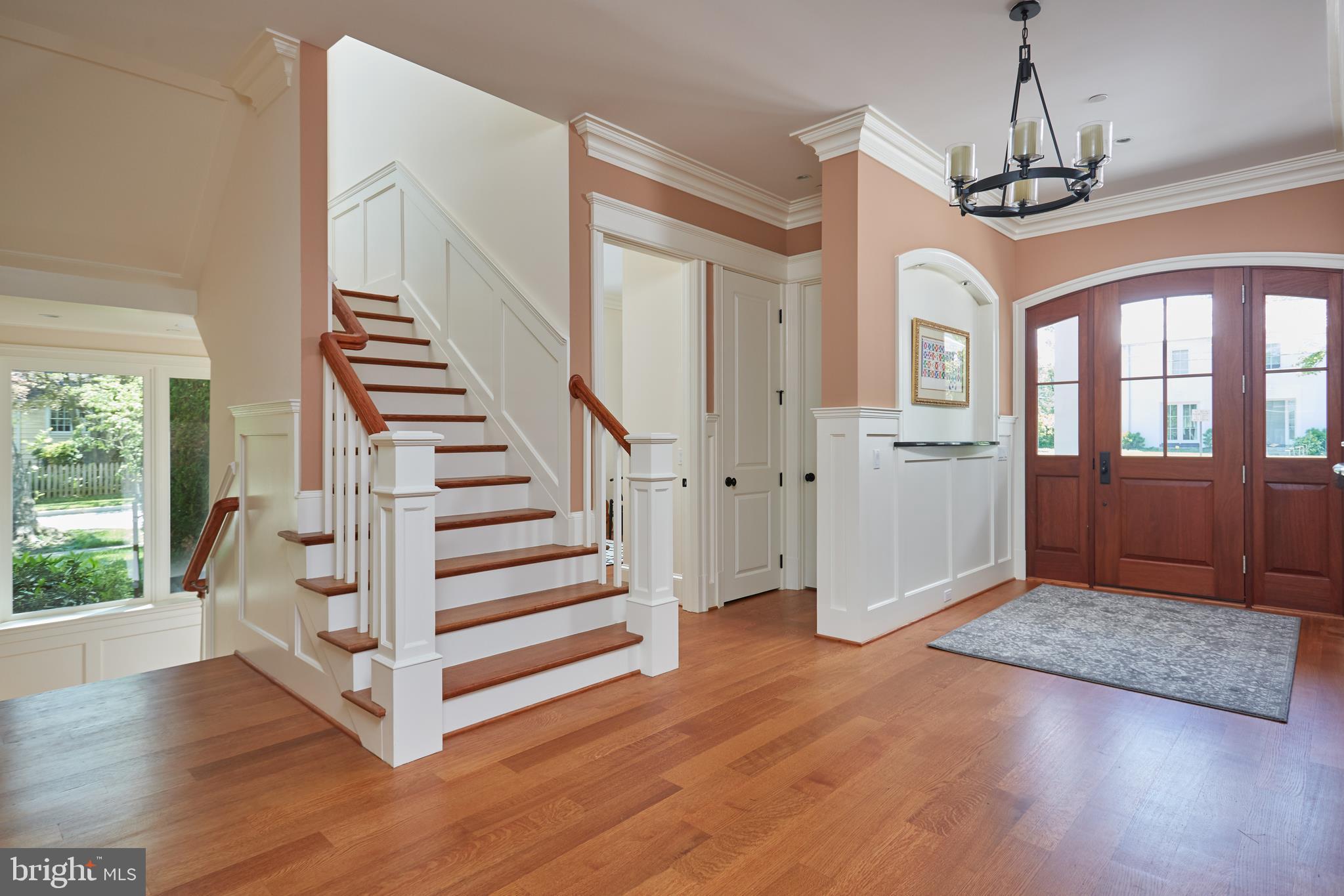 8003 Maple Ridge Road Bethesda, MD 20814 - Photo 7 of 30 a view of a hallway with wooden floor and stairs